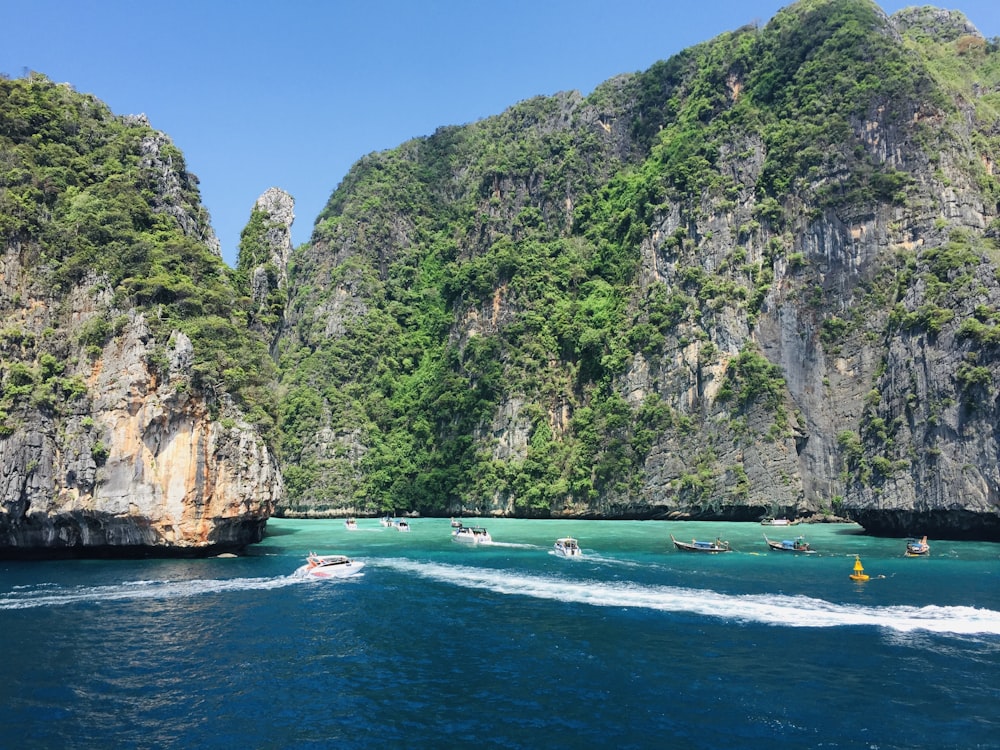 green and brown mountain beside body of water during daytime