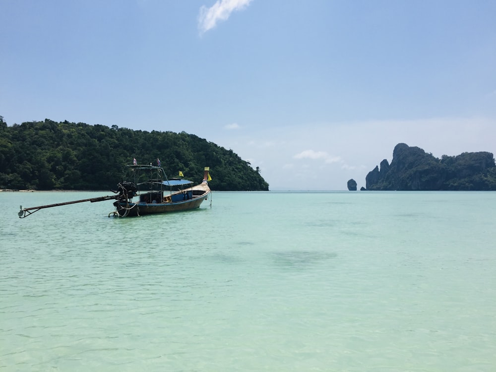 white and black boat on sea during daytime