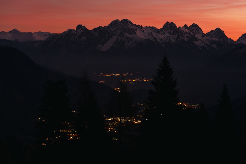 silhouette of trees and mountains during sunset