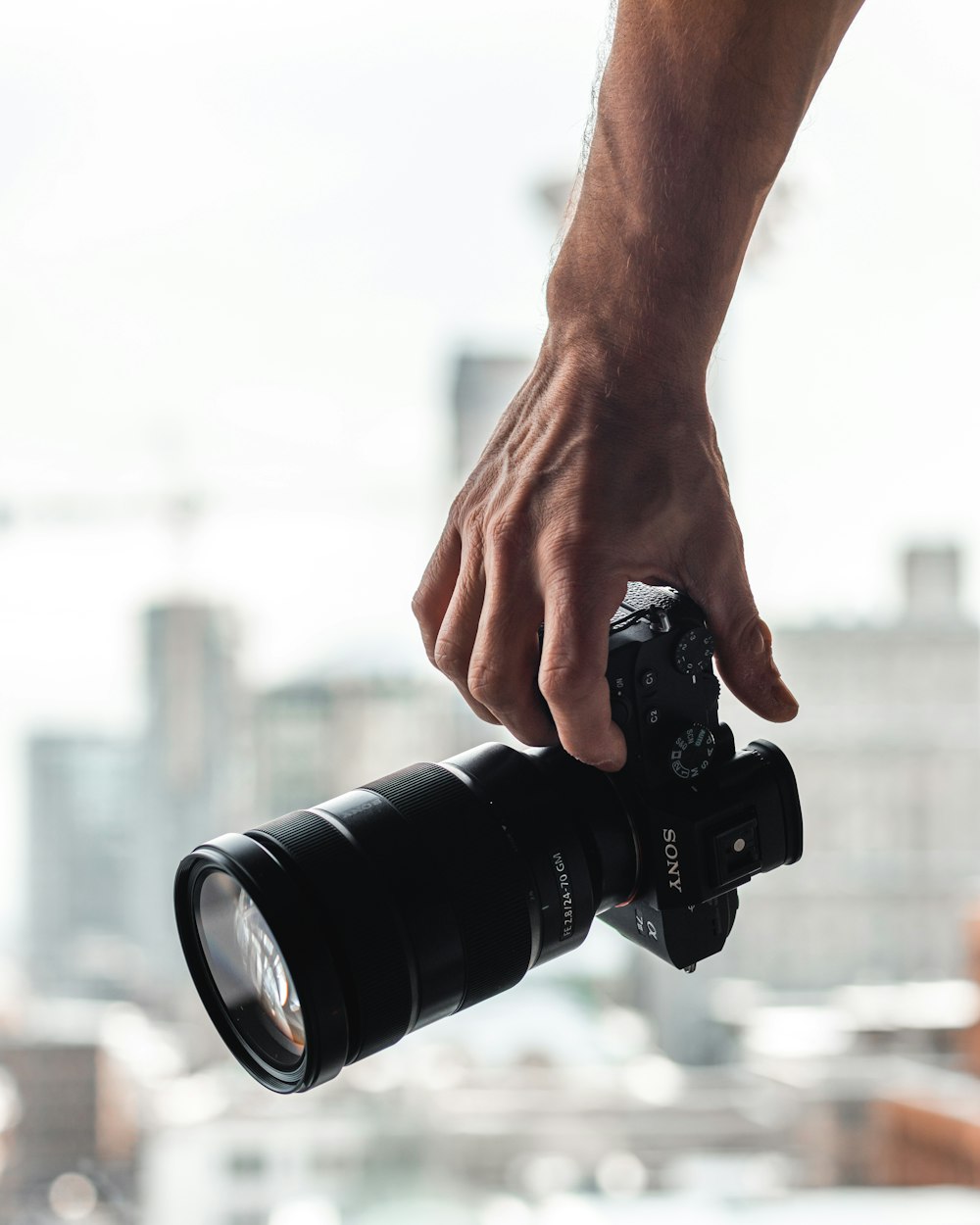 person holding black dslr camera