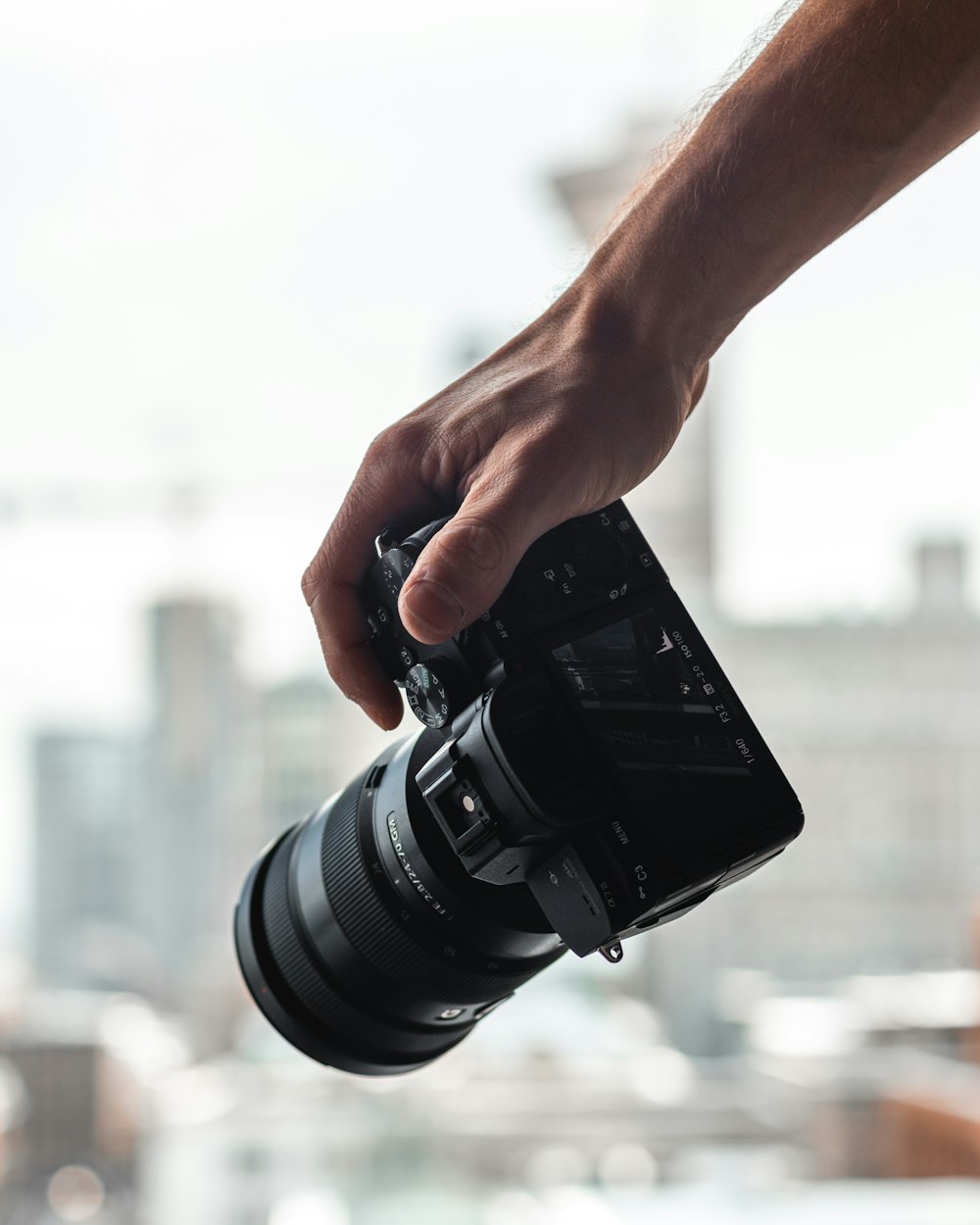 person holding black dslr camera