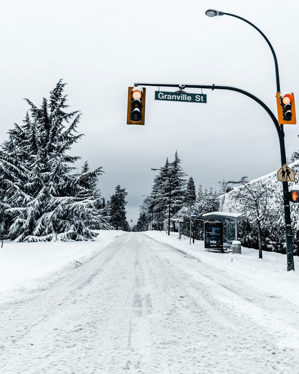 black traffic light on snow covered ground