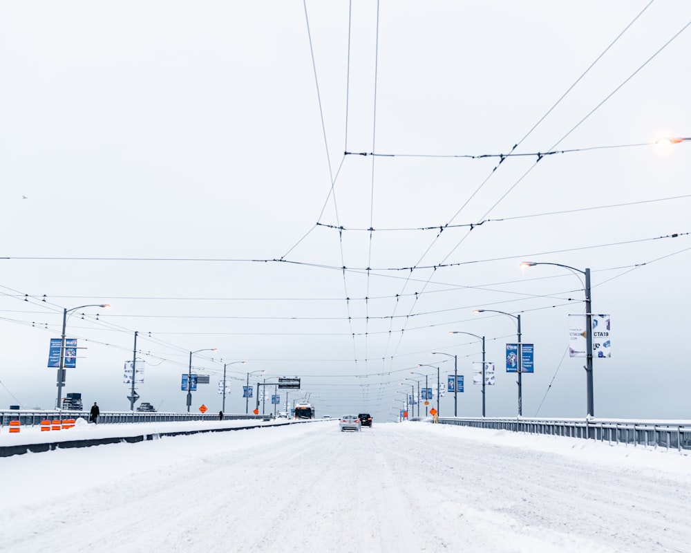 cars on road covered with snow during daytime