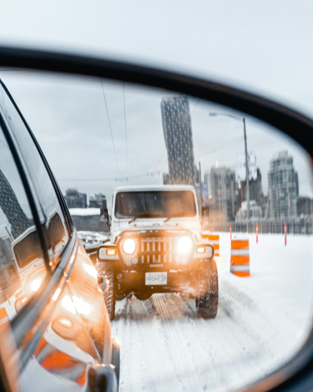 yellow car on road covered with snow during daytime