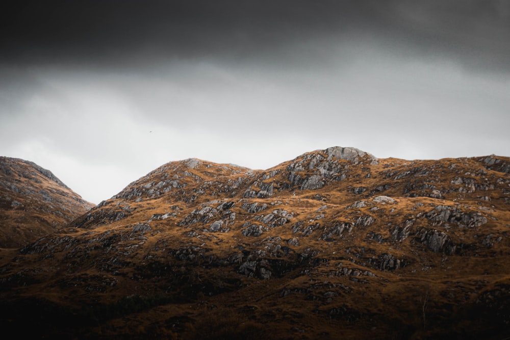 brown and gray mountain under gray sky