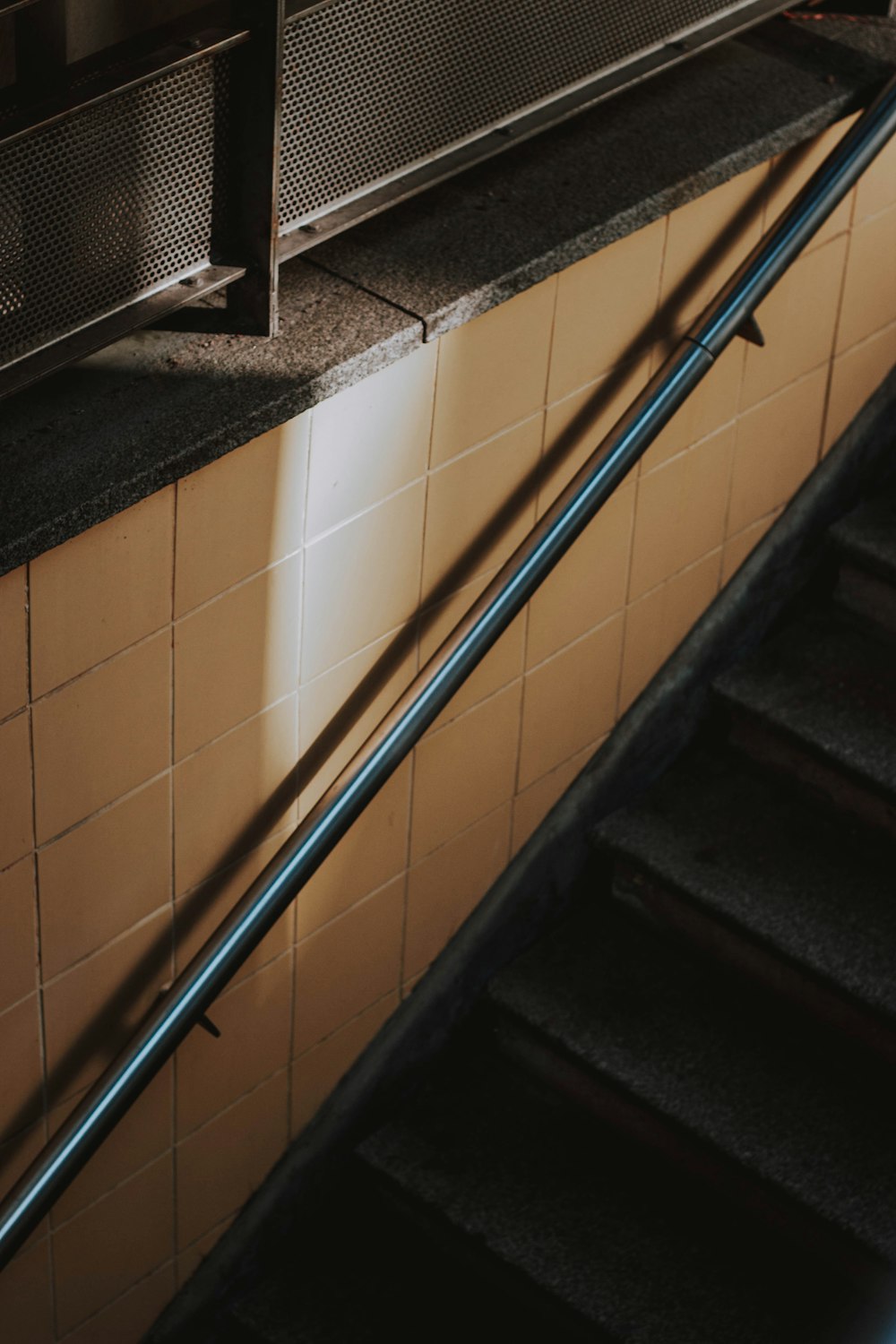 an escalator in a subway station with tiled walls