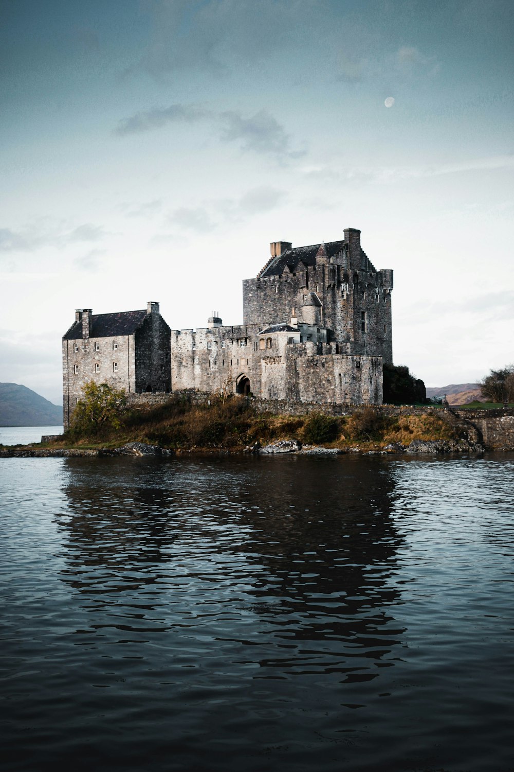 an old castle sitting on top of a small island