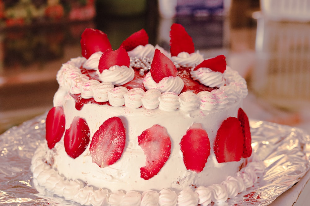 white and red cake with strawberry on top