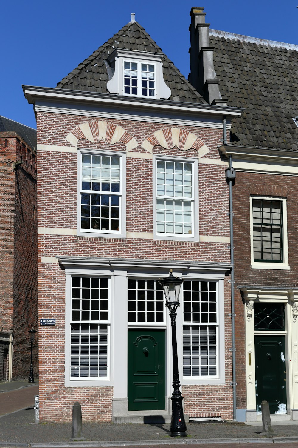 brown brick building with white wooden windows