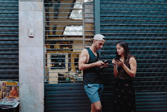 A friendly security guard using a smartphone to manage visitor access at a gated community entrance.