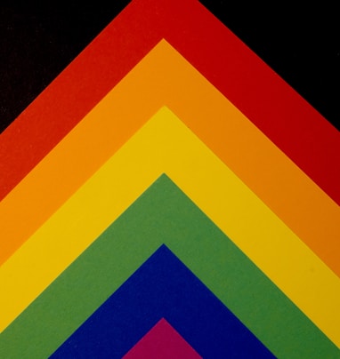 a close up of a multicolored triangle on a black background