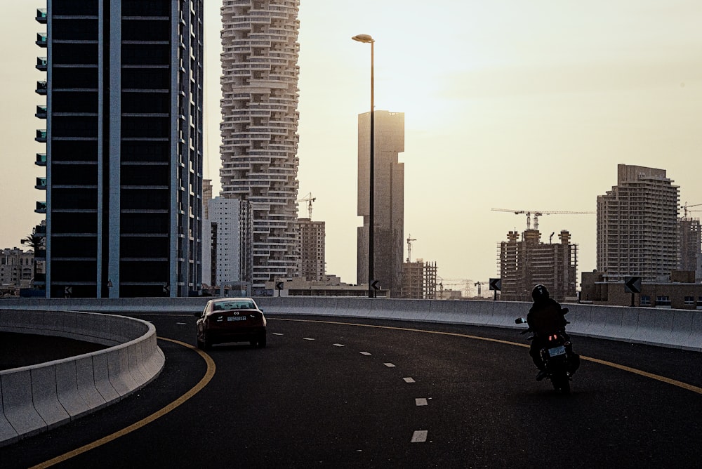 a person riding a motorcycle on a city street