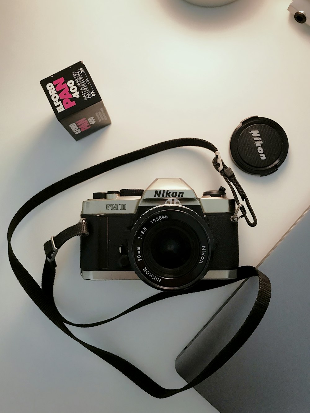 a camera sitting on top of a white table