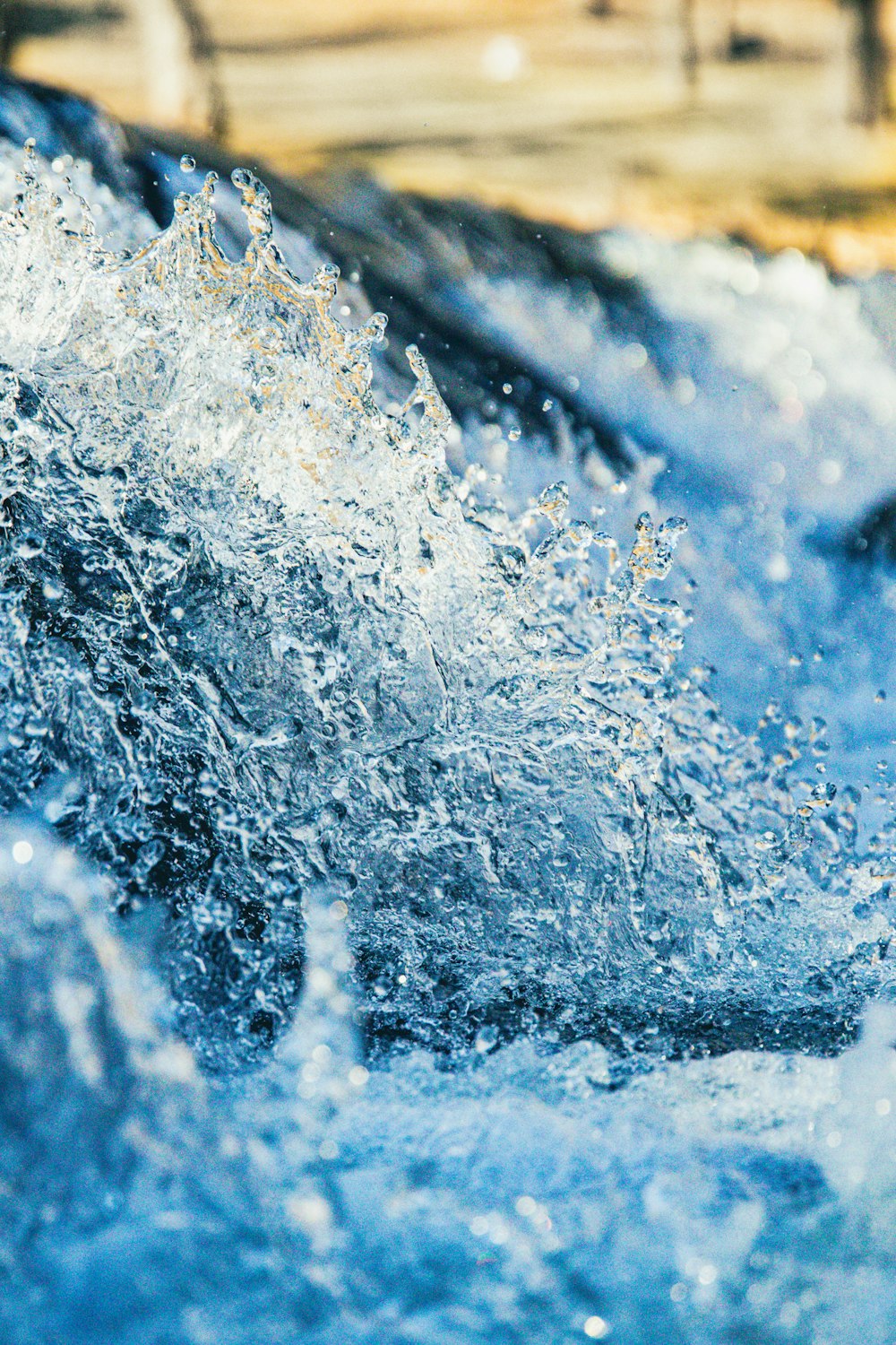 a close up of water splashing on the surface of a body of water