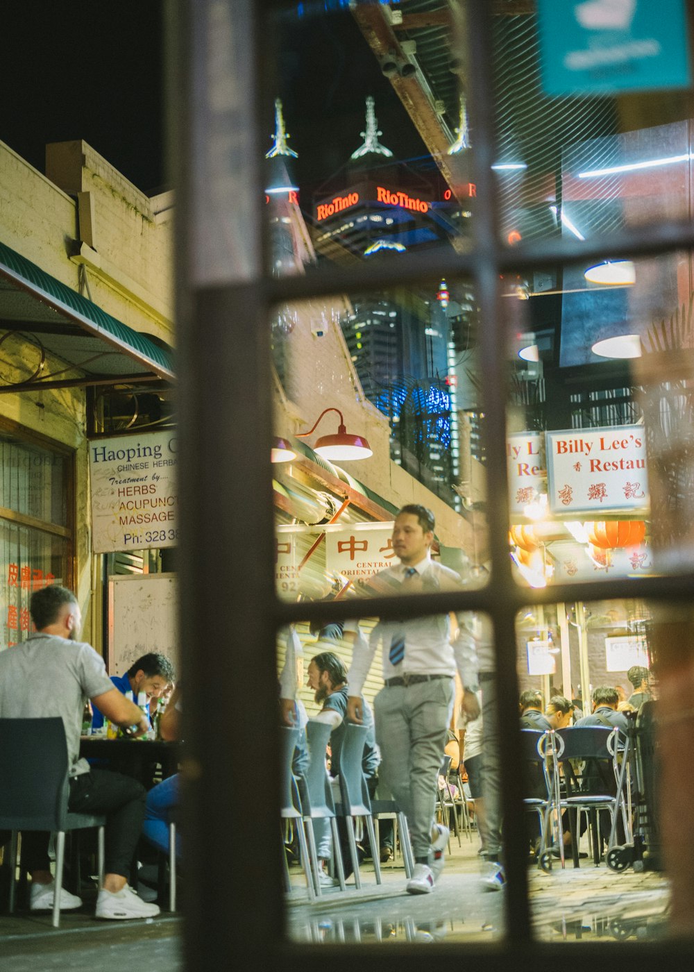 a group of people sitting at tables in a restaurant