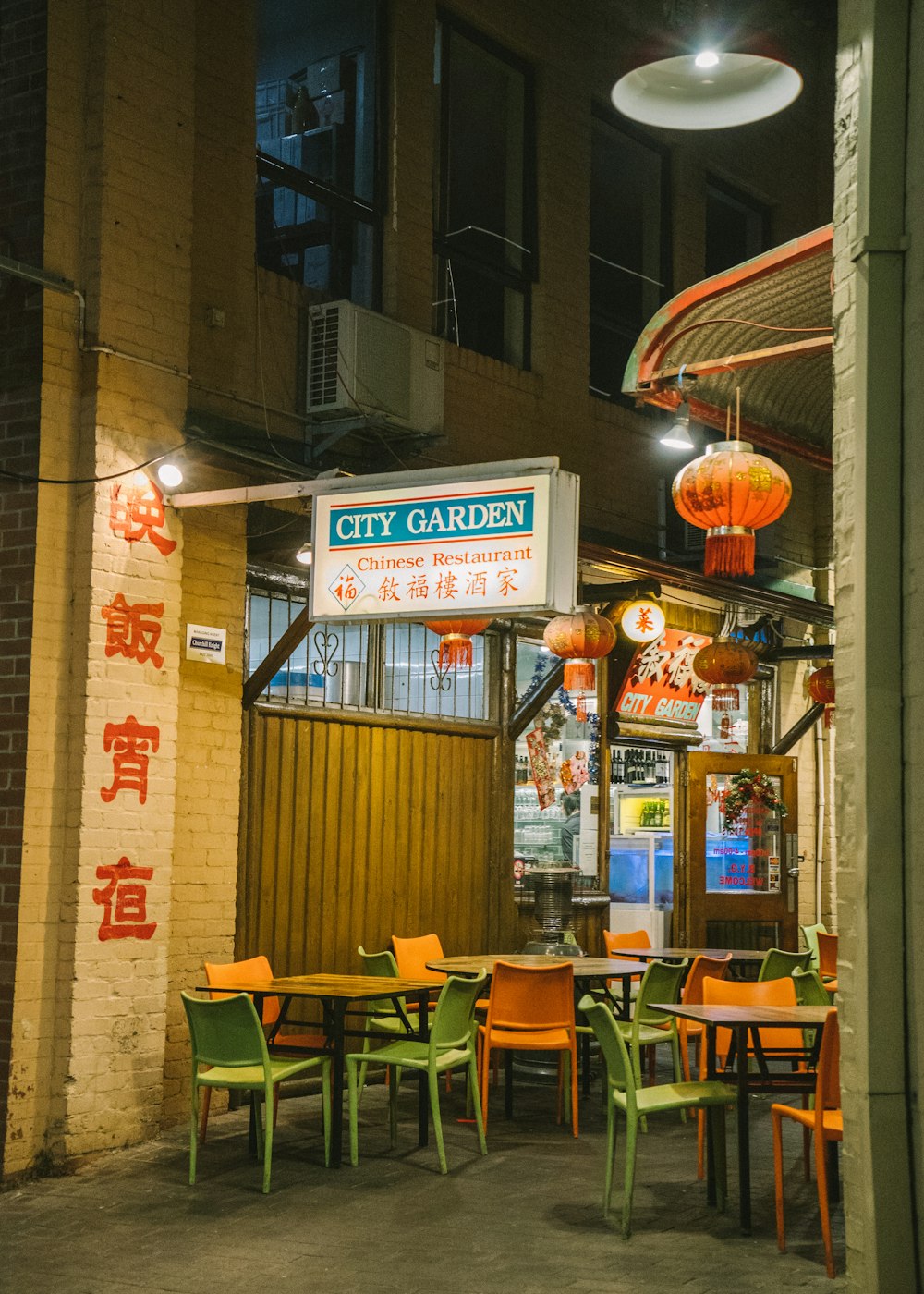 a restaurant with tables and chairs in front of it