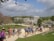 A group of travelers exploring a lush Maya archaeological site surrounded by greenery.