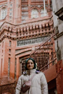 Winter look with a long coat, layered skirt, and cozy hijab.
