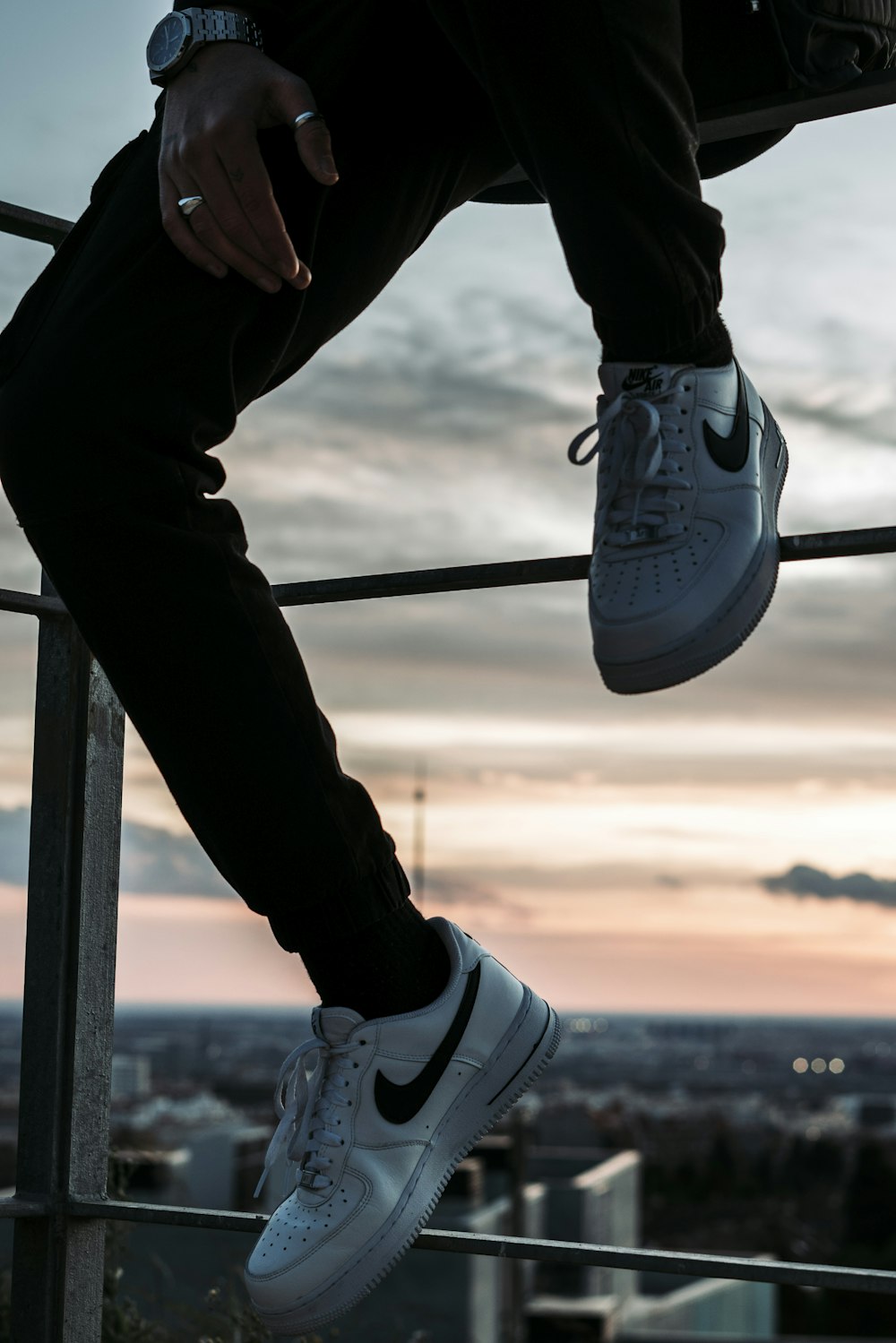 a person sitting on a ledge with their feet up
