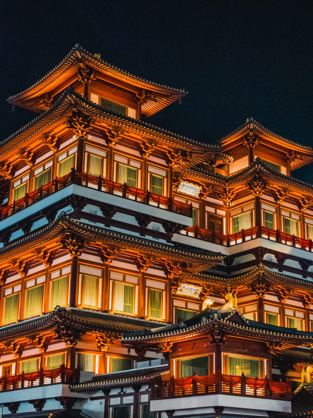 a tall building with many windows lit up at night