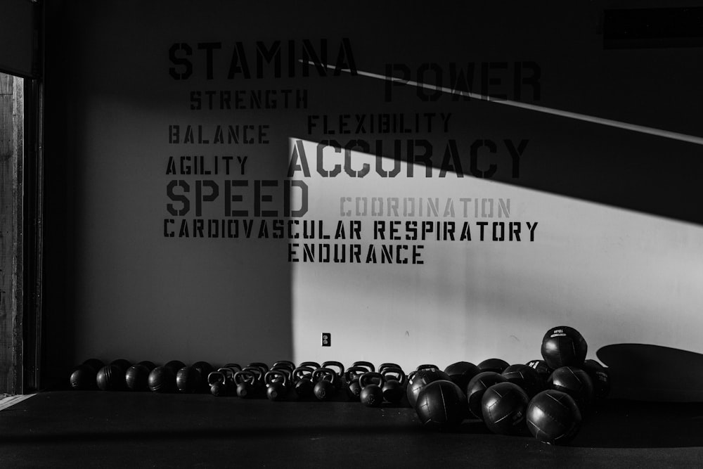 a black and white photo of a row of kettlebells