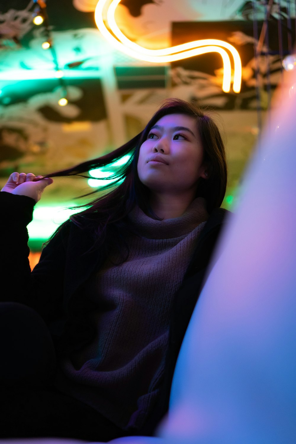 a woman with long hair sitting in a chair