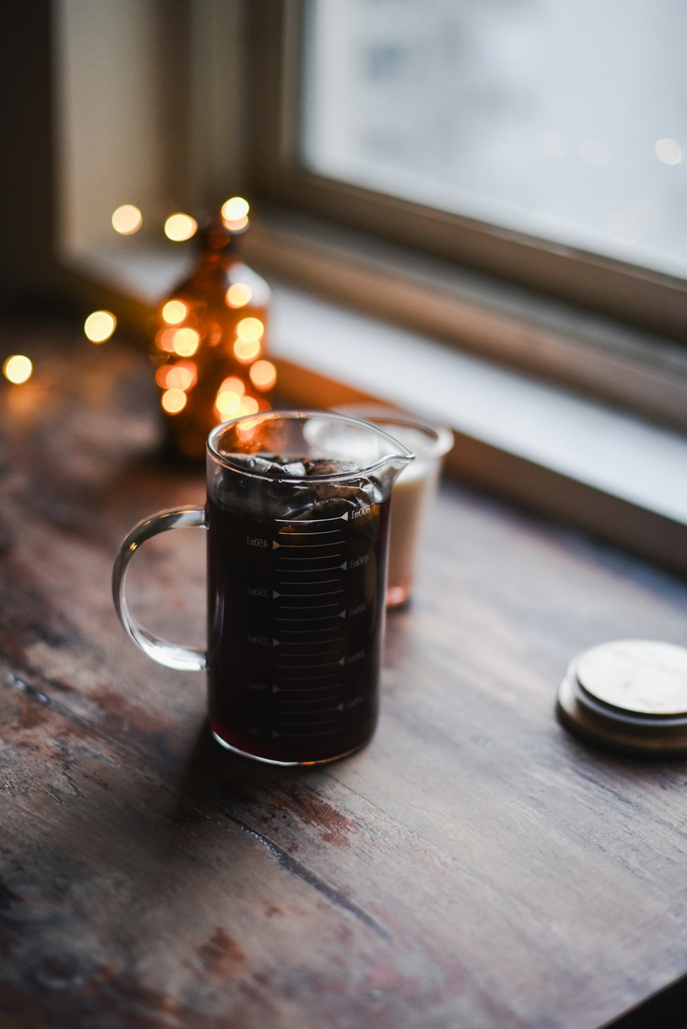 a cup of coffee sitting on top of a wooden table