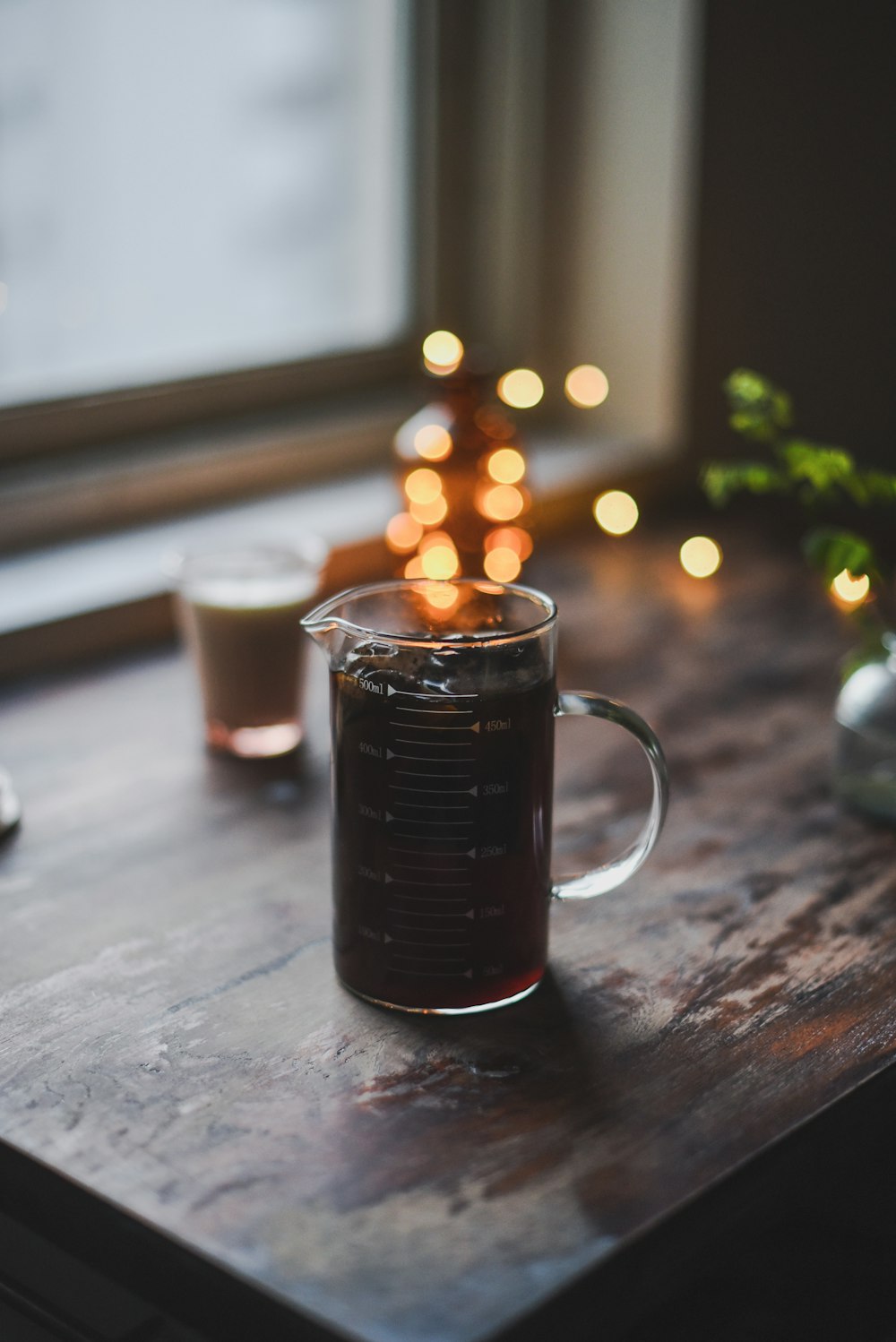 a cup of coffee sitting on top of a wooden table