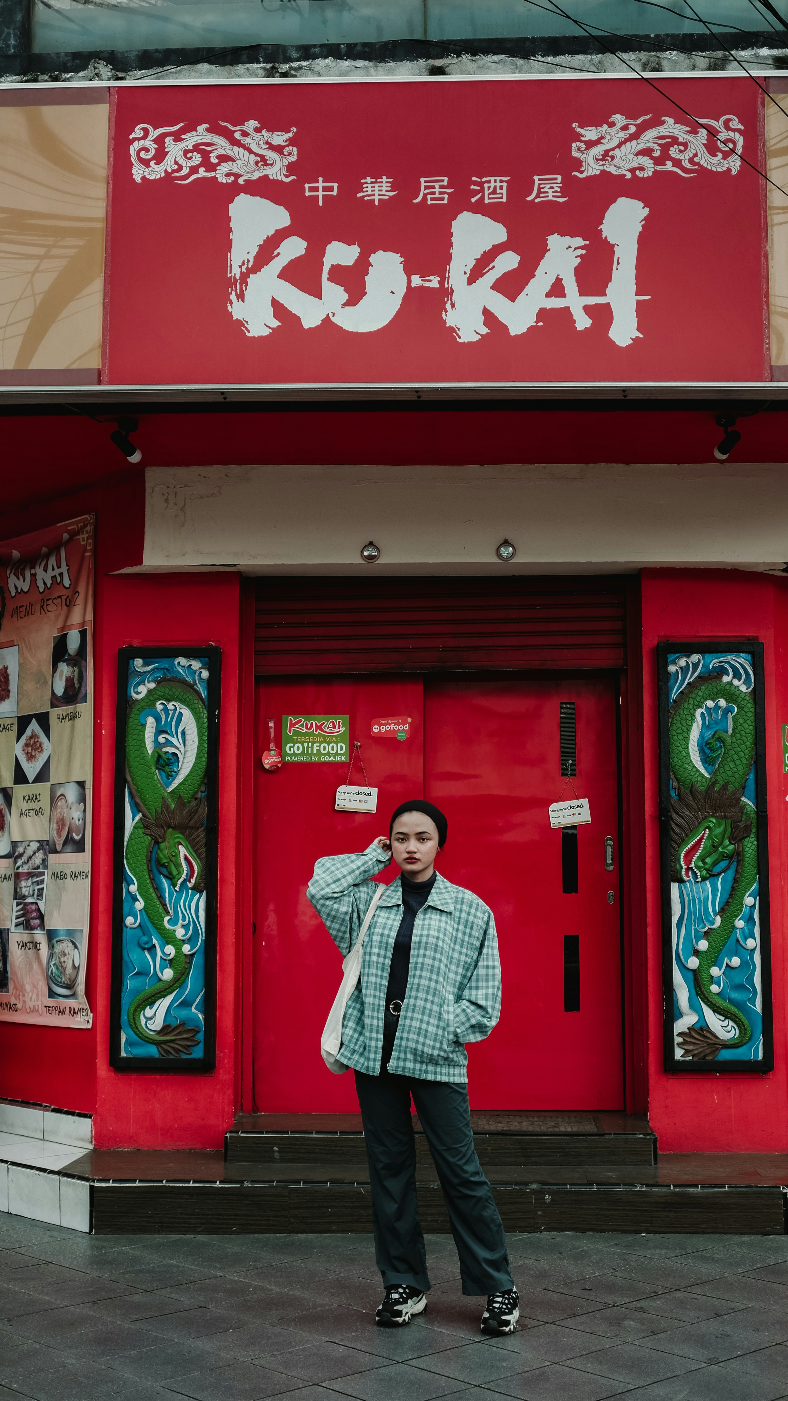A man standing in front of a red building photo – Free Art Image on ...
