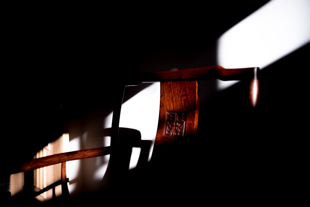 the shadow of a wooden chair on a wall