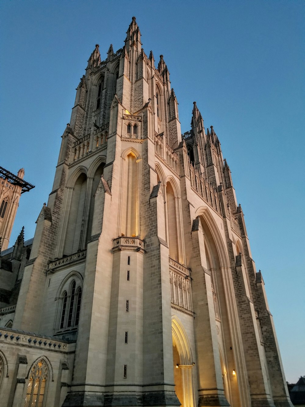 a tall cathedral with a clock on the front of it