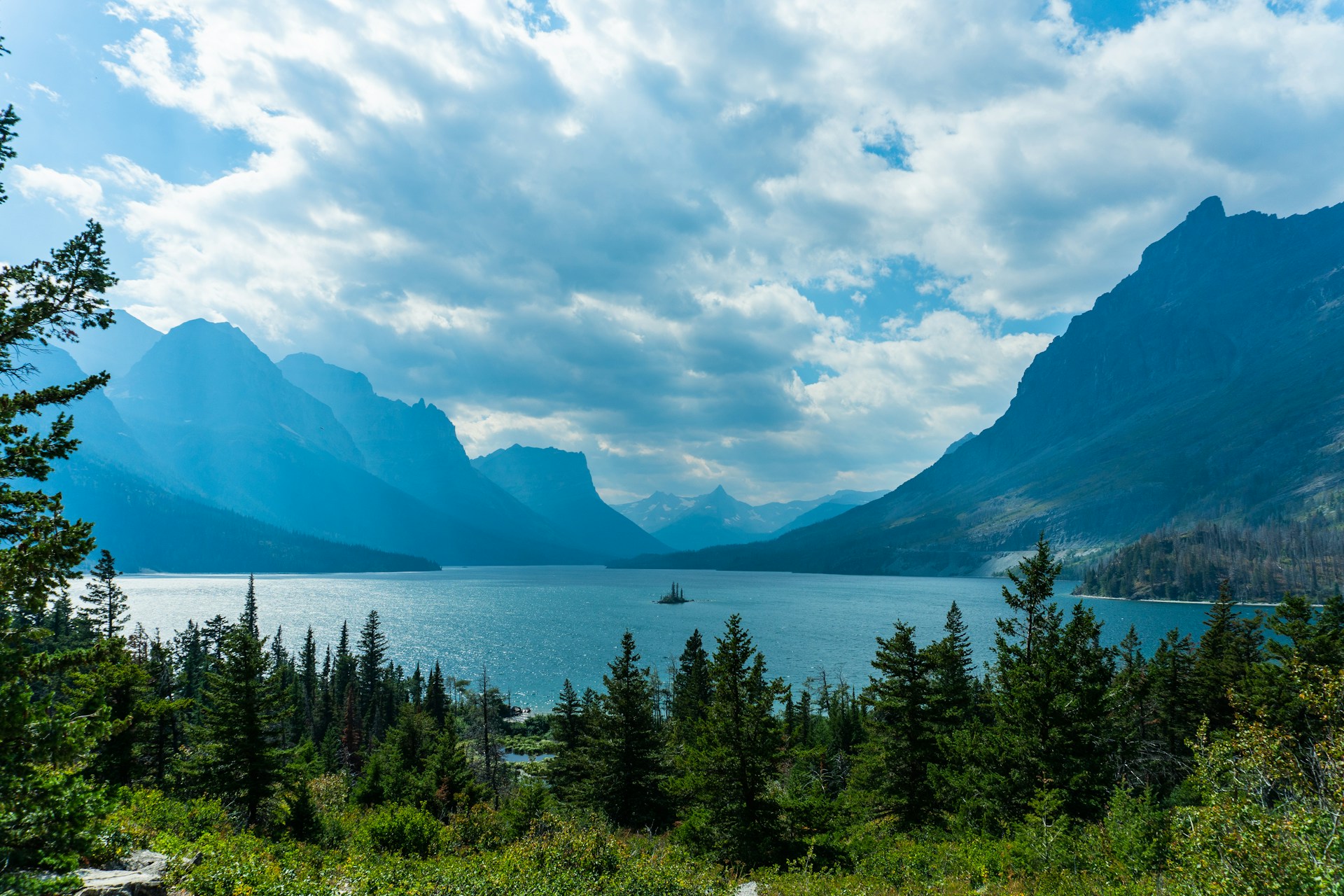 a scenic view of a lake surrounded by mountains