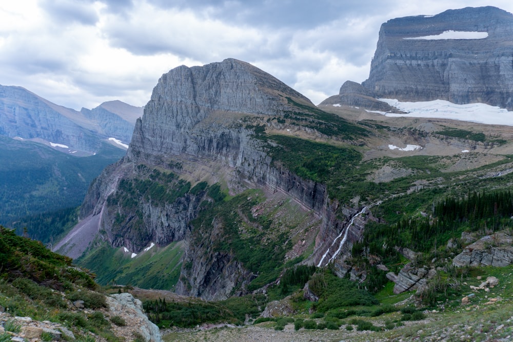 a view of a mountain range from the top of a hill