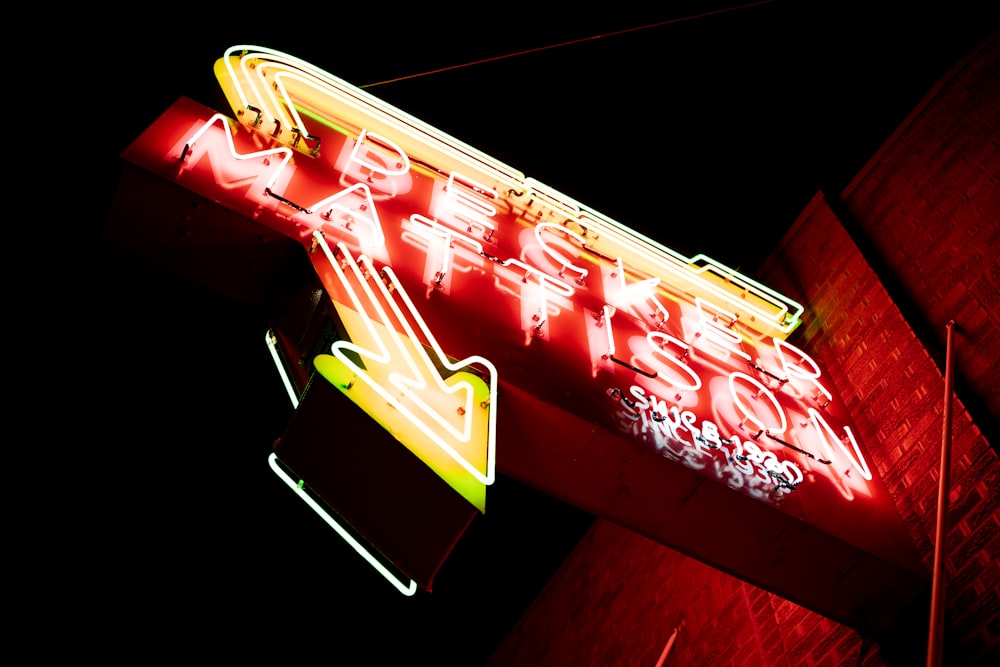 a neon sign that is on the side of a building