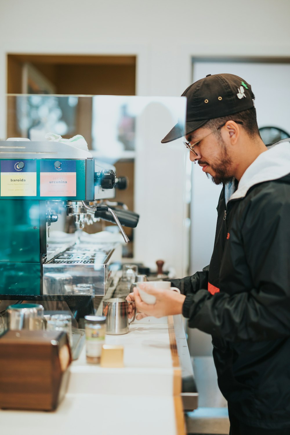 a man standing in front of a coffee machine