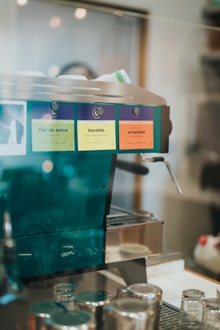 Variety of automatic coffee machines lined up on a wooden kitchen countertop.