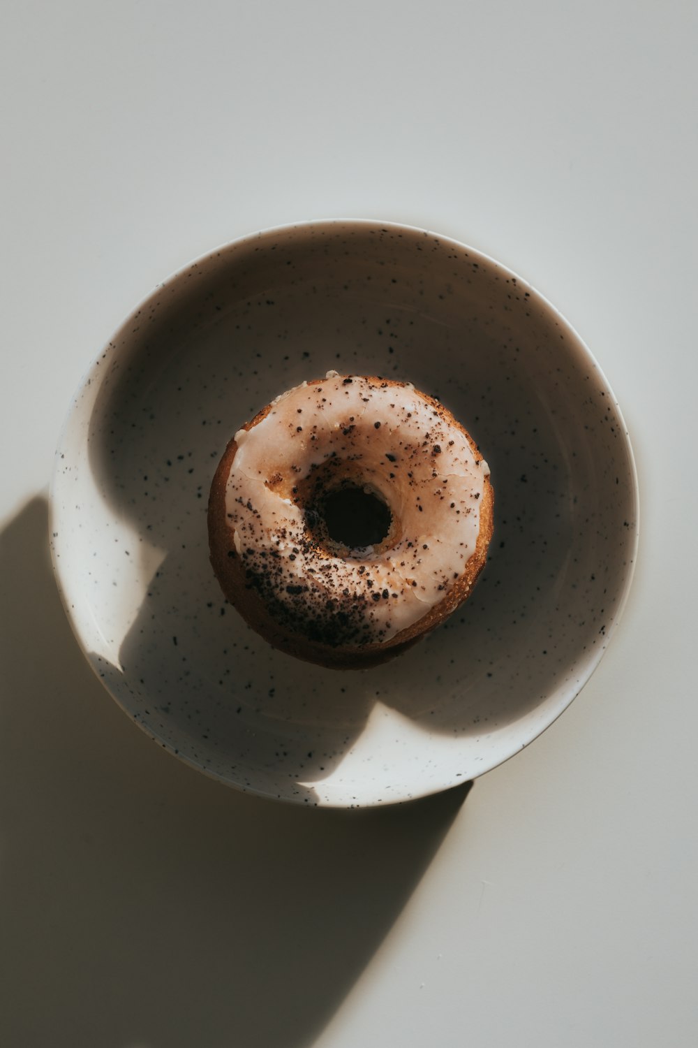 a donut sitting in a white bowl on a table