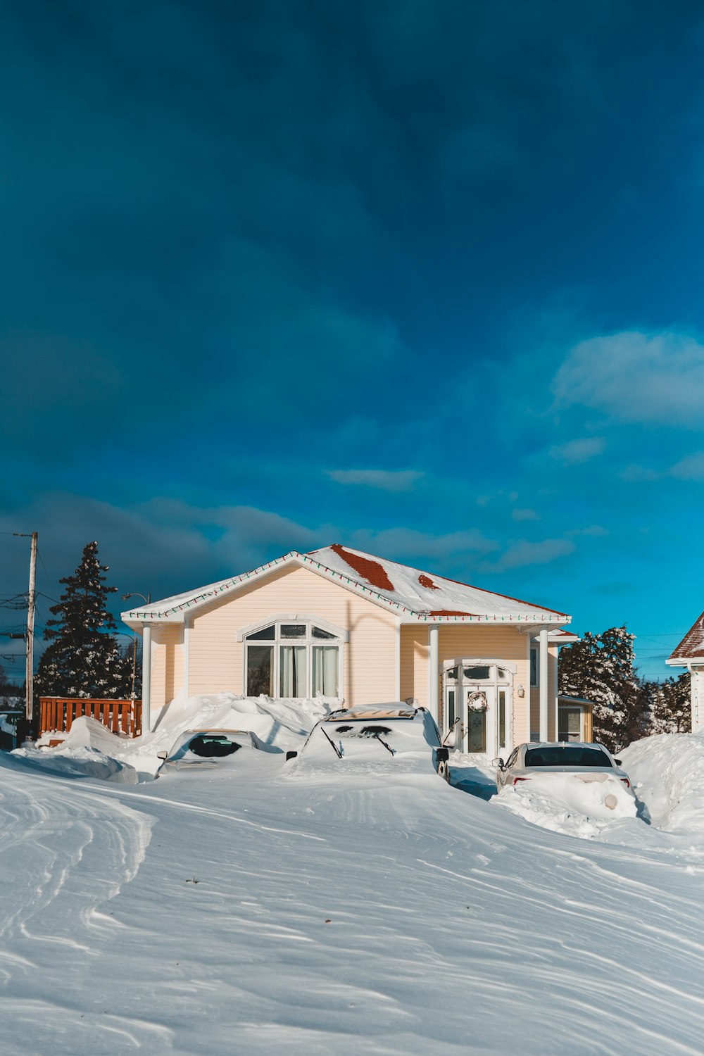 a house in the middle of a snowy field