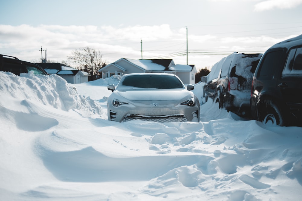 a white car is parked in the snow