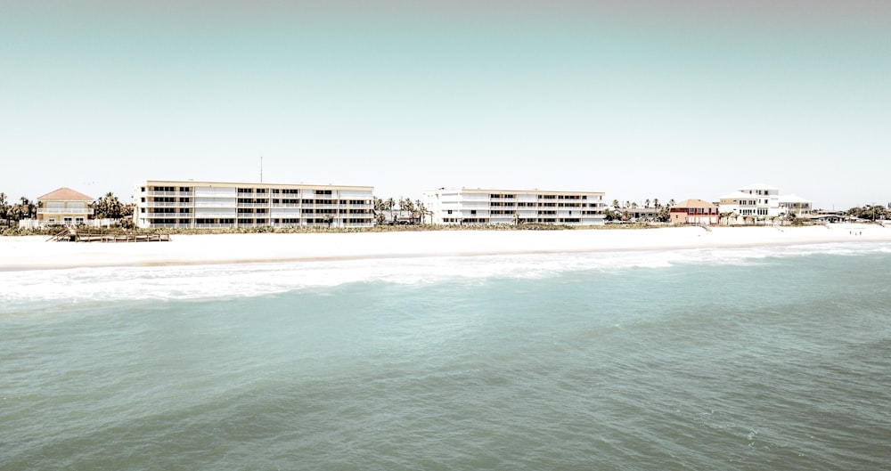 a view of a beach with a hotel in the background