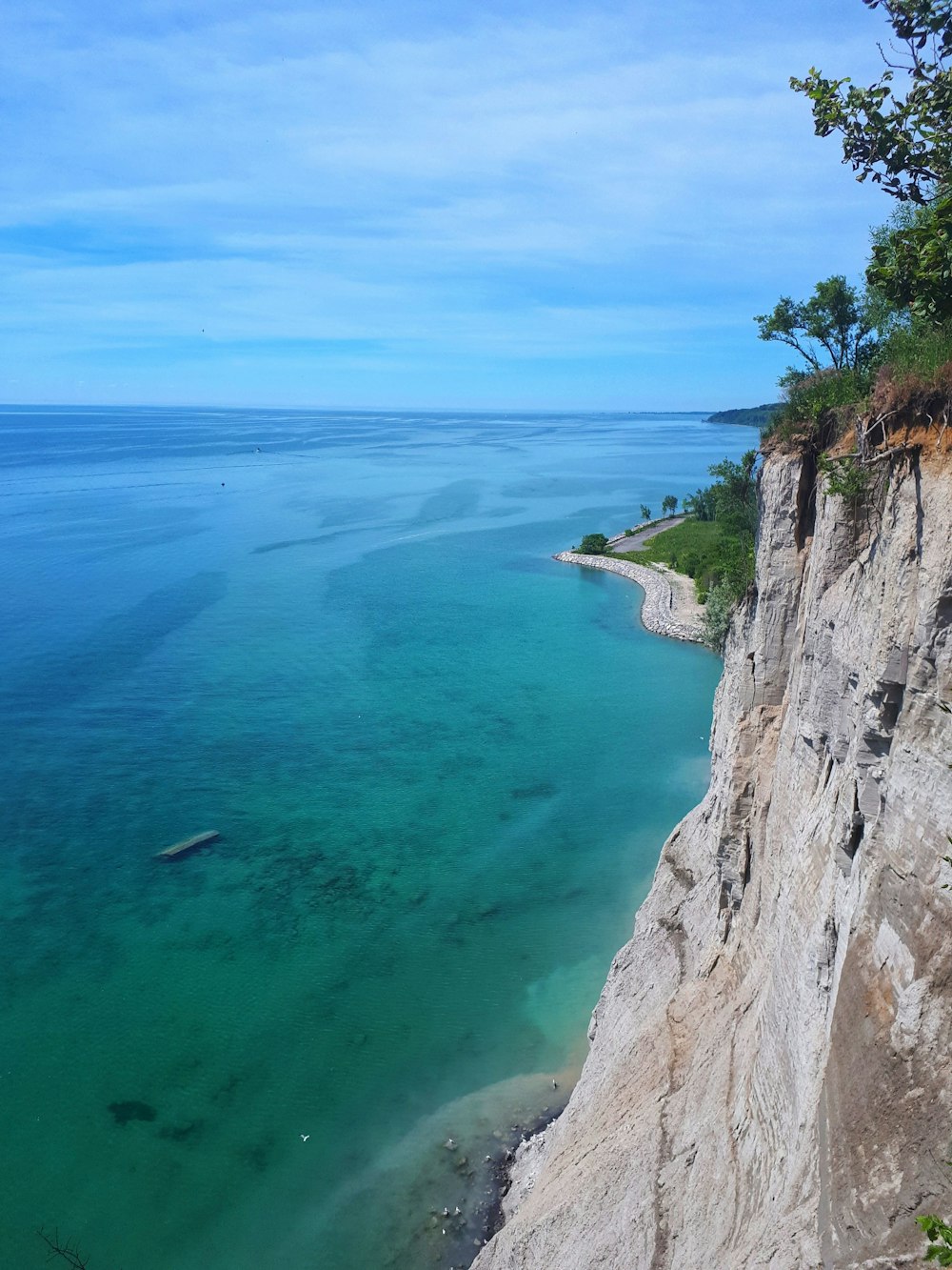 a large body of water sitting next to a cliff