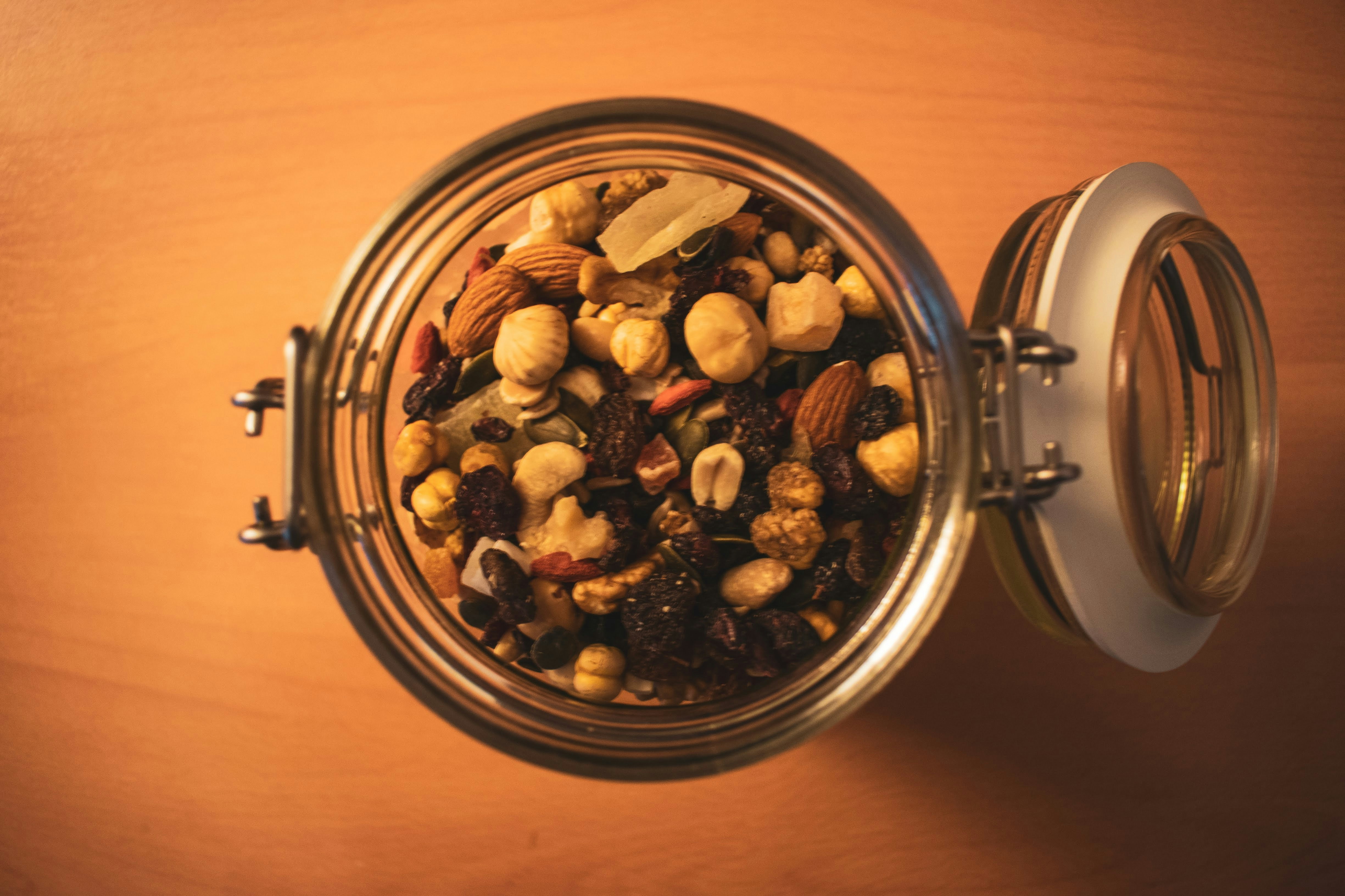 Glass jar filled with premium mixed nuts and colorful dried fruits