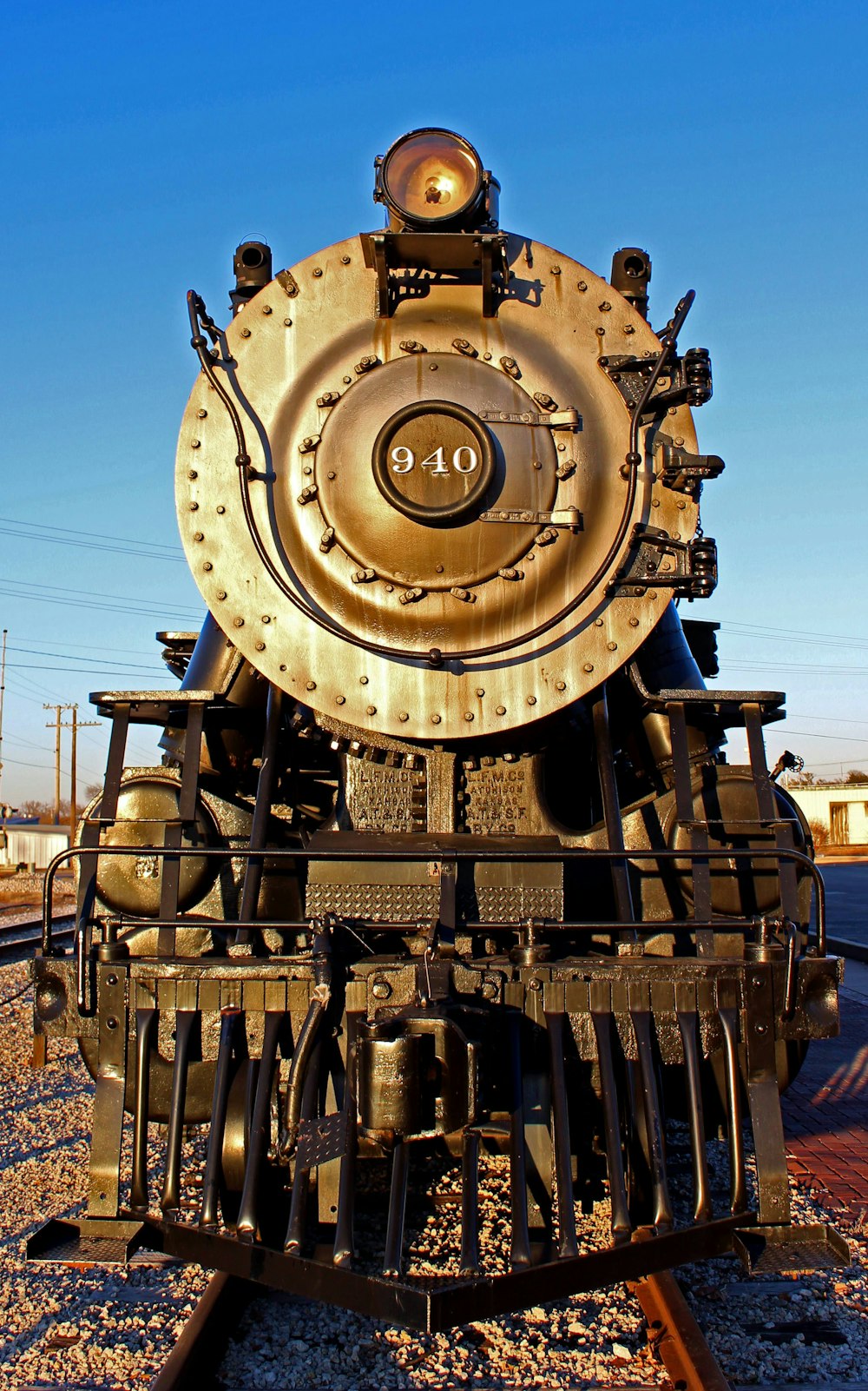 brown and black train under blue sky during daytime