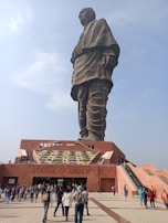 The towering Statue of Unity standing proudly against a backdrop of rolling hills.