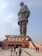 Smiling middle-aged man enjoying the Statue of Unity tour with a scenic background.