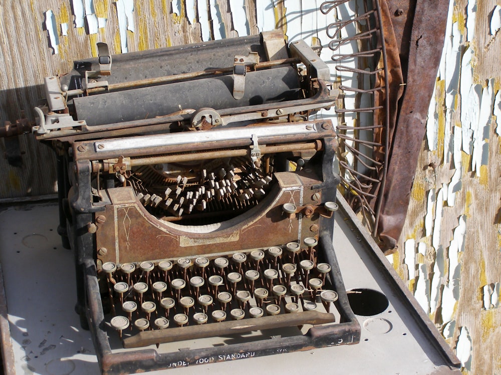 black and gray typewriter on white table