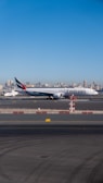 white and red airplane on airport during daytime