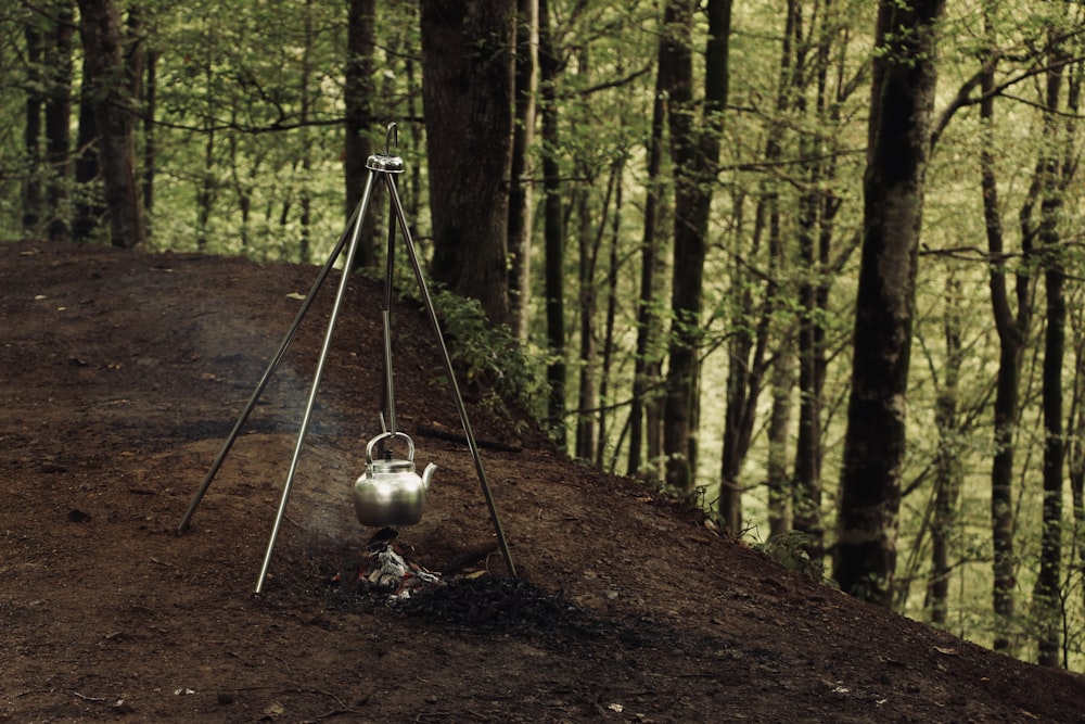 a tea kettle sitting on top of a dirt hill