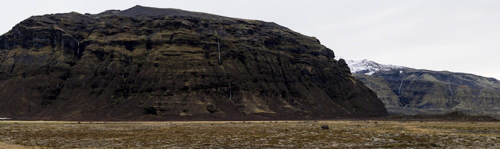 a large rock formation in the middle of a field