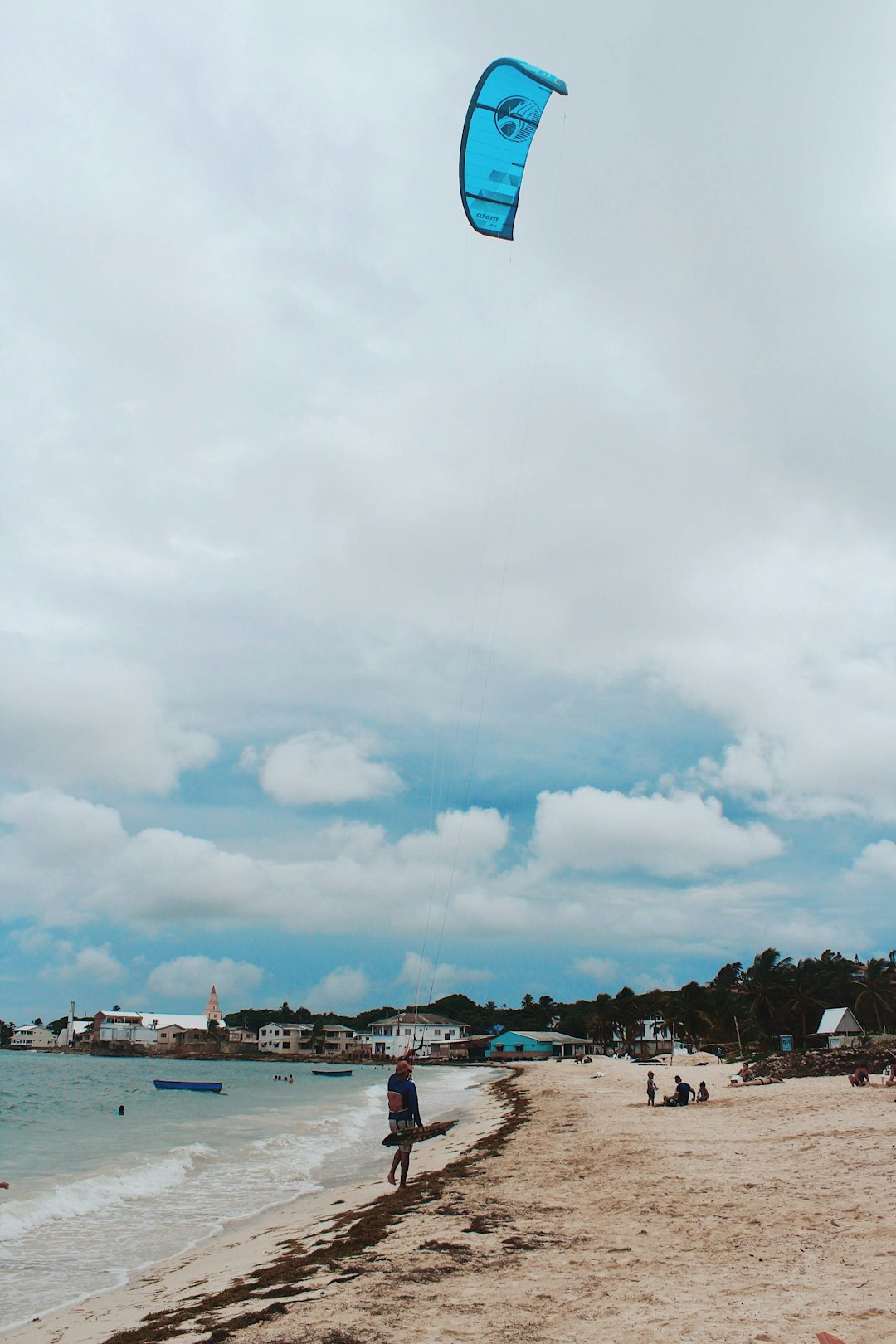 people on beach under cloudy sky during daytime